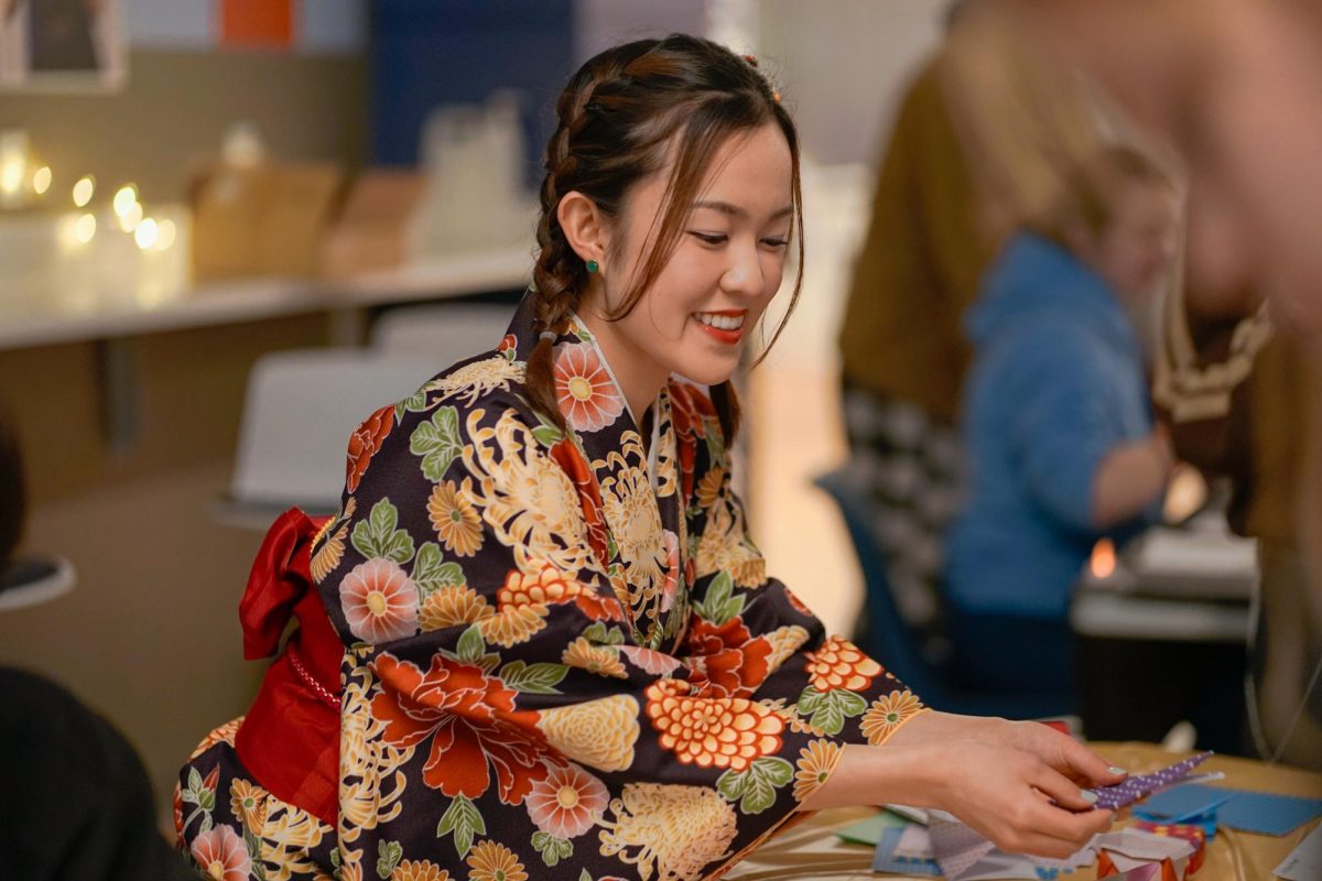 Senior Norika Maeda wears a Kimono at the International Street Fest at Lindberg Center on April 26, 2024. Maeda provides calligraphy for attendees as part of her table.