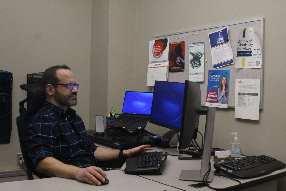 Dimitrios Jason Stalides, Director of the Office of Disability Services, works in his office inside the Learning Commons in Olin 320 at Augustana College.