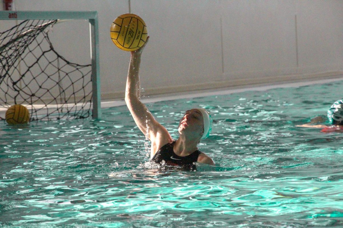 Sophomore Carli Udovich passes a throw during an Augustana College Women’s Water Polo team practice session for nationals at Lindberg on April 30, 2024.