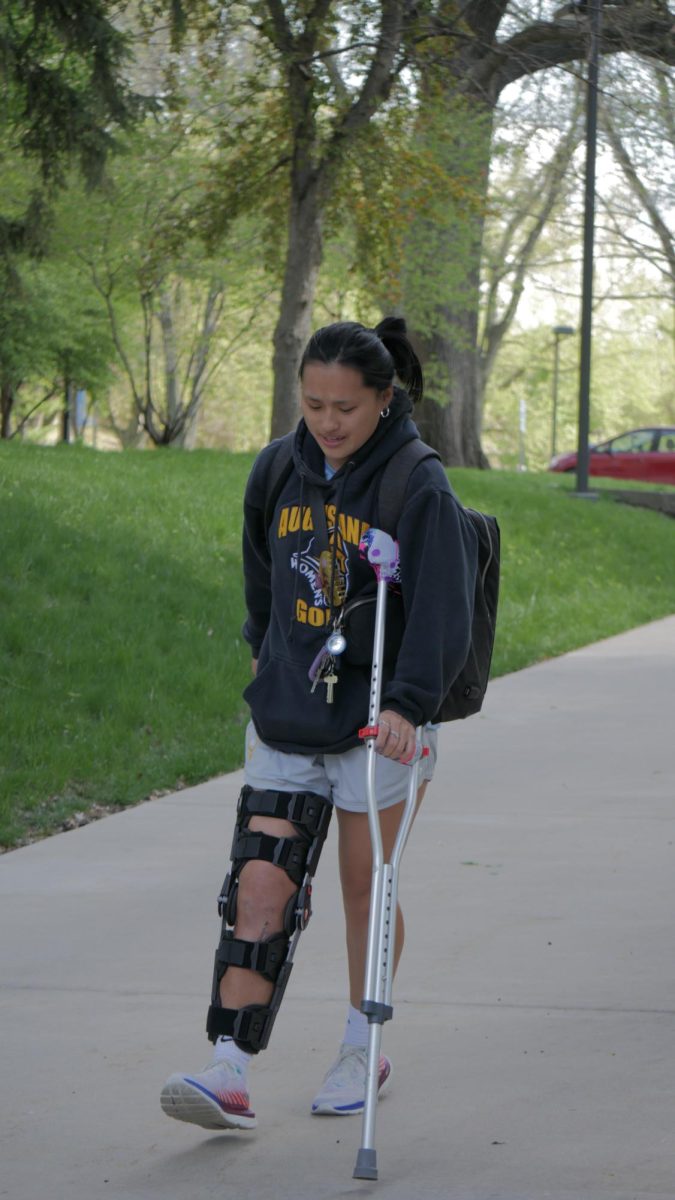Karli Brosch, junior, crutches around campus on April 23, 2024. Borsch was injured this year in a lacrosse game. 
“After the injury, I felt like I took living and walking for granted,” Borsch said.