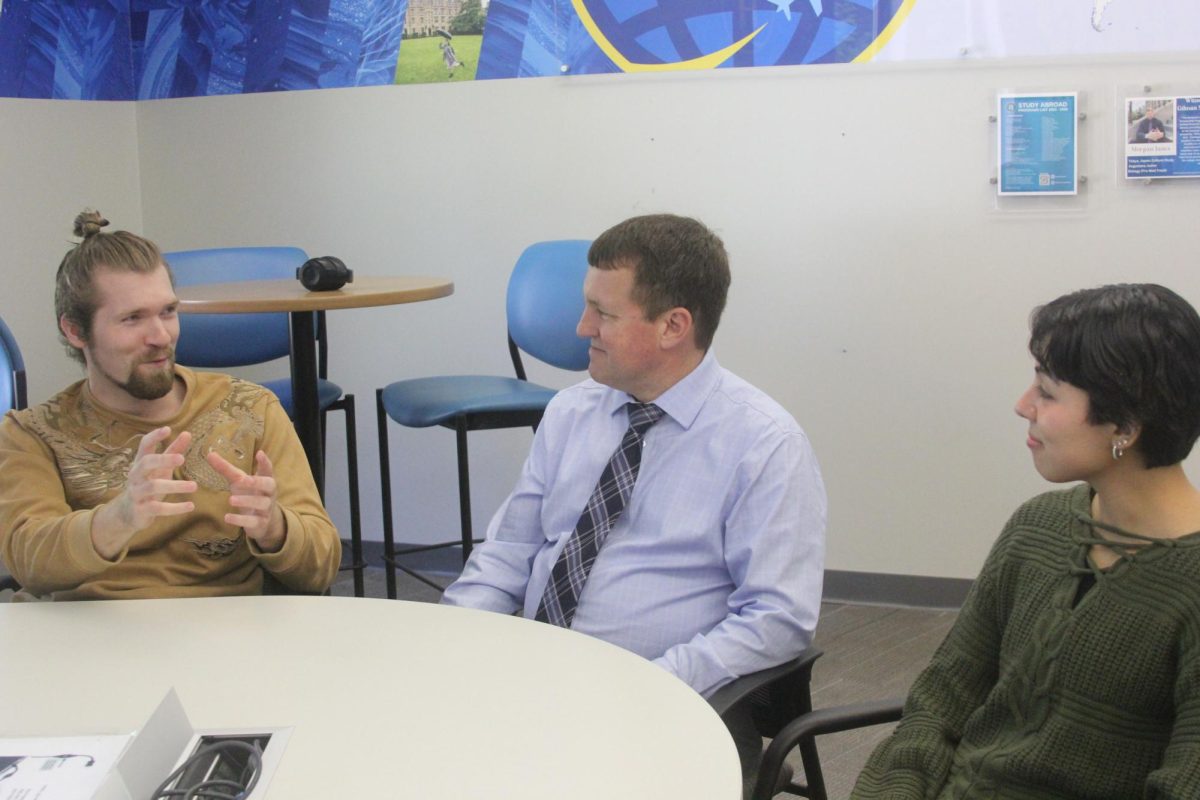 Senior Morgan Janes (from the left, Benjamin A. Gilman International Scholarship
recipient), Augustana’s Director of International and Off-Campus Projects Steven Duke
and Junior Marlene Cabada (Benjamin A. Gilman International Scholarship recipient)
talk about the students’ experience with the scholarship in CORE Commons Area.