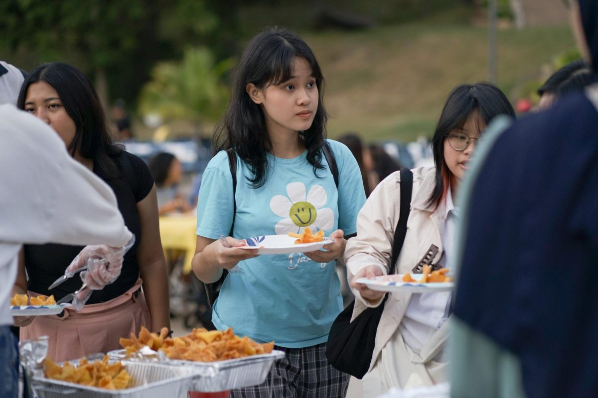 First-Year Tram Nguyen waits in line for food at Moon Festival at Low Quad on Sep 20, 2024. The Moon Festival is an annual event hosted by the Asian Student Organization and Vietnamese Student Association where students can learn about the festival, enjoy food and performances.