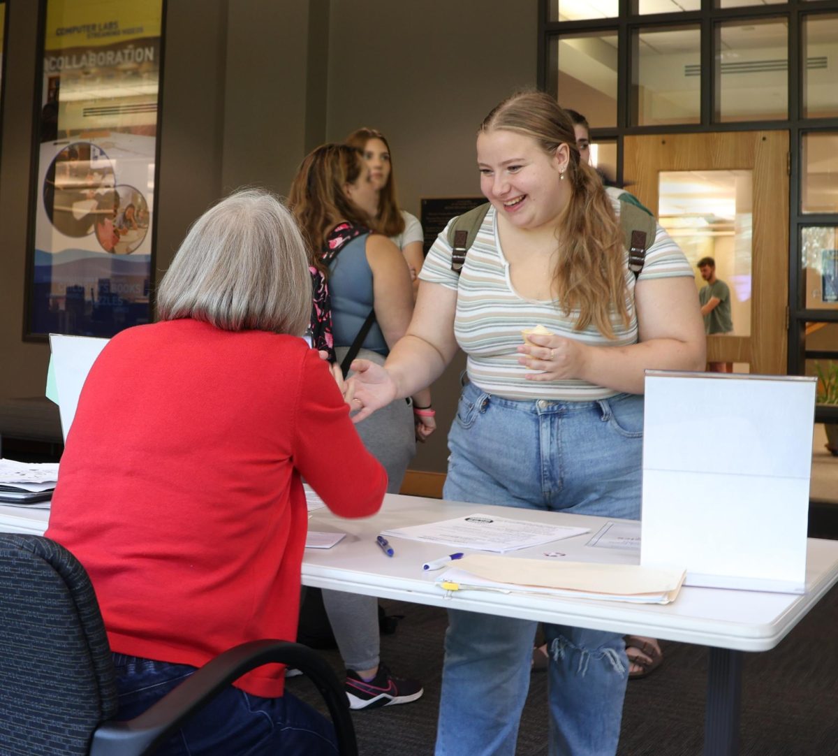 First-Year Katelyn Nimmo gets registered to vote with help from The League of Women Voters in Tredway Library lounge on Wednesday, Oct. 2, 2024.