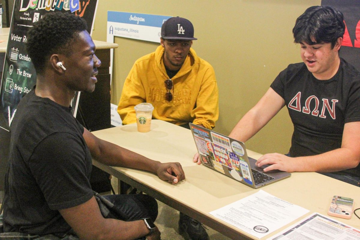 Senior Mark Hall completes the procedure for voter registration under the guide of Junior Aron Stewart and Junior Brayden Atkisson on Oct. 18 in the Brew.