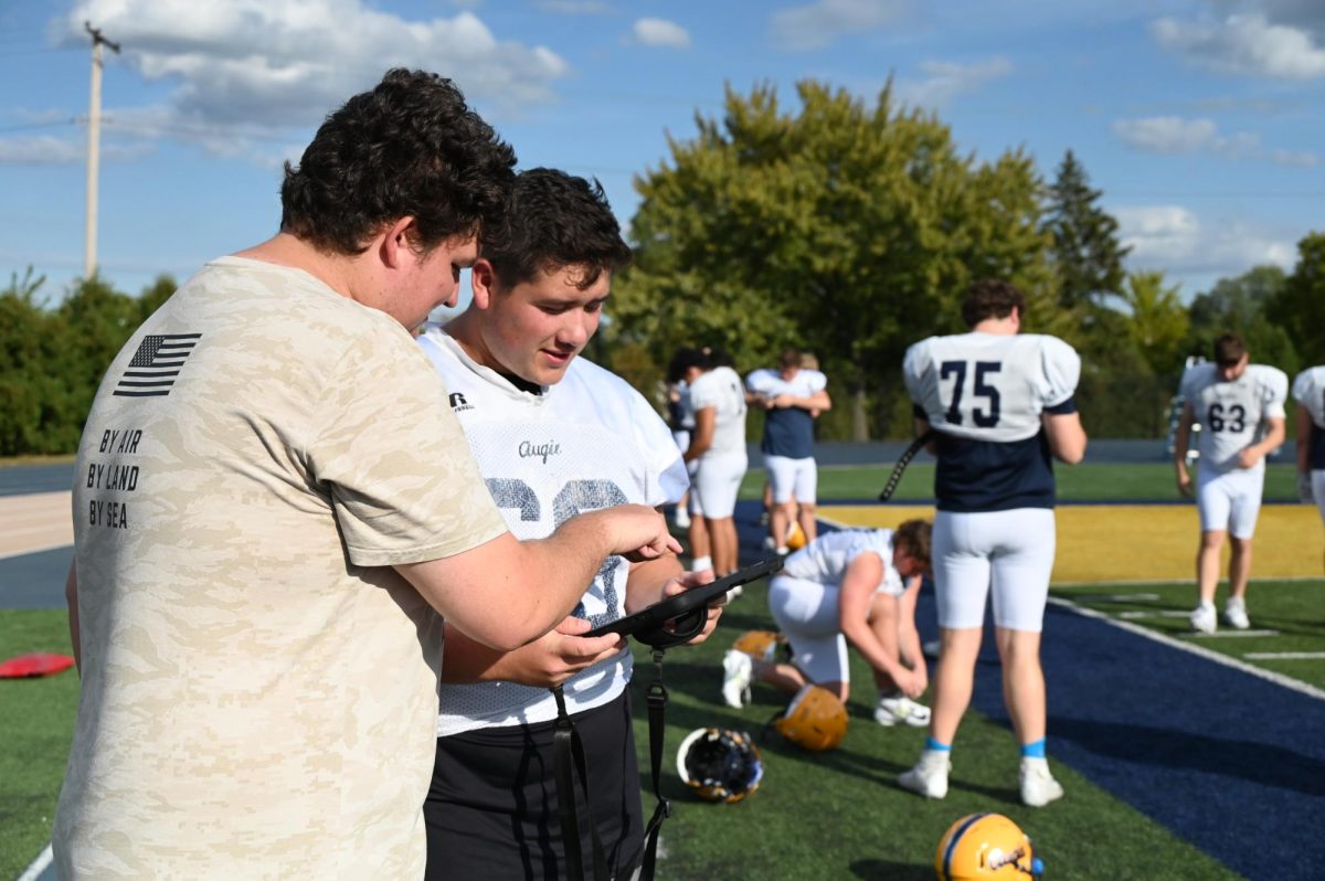 Sophomores Evan Palfenier and Zach Ott review footage from the filming system.