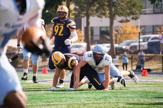 Elmhurst University's defense swarms to tackle Augustana's defensive line Magnus Wells #96 at the line of scrimmage at the home game against Elmhurst University on Oct. 12, 2024, at Lindberg Stadium.