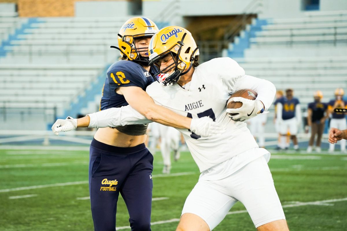 Senior Johnny Breeden attempts to contain Junior Jake Miller during a drill at the football practice, demonstrating proper tackling technique, at Lindberg Stadium on Oct. 16, 2024.