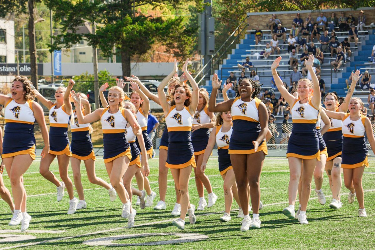 Augustana College cheerleaders rally the crowd during the 2024 Homecoming game on Oct. 5, 2024, at Lindberg Stadium. The squad's high-energy performance maintains school spirit as the Vikings face off against North Park University.