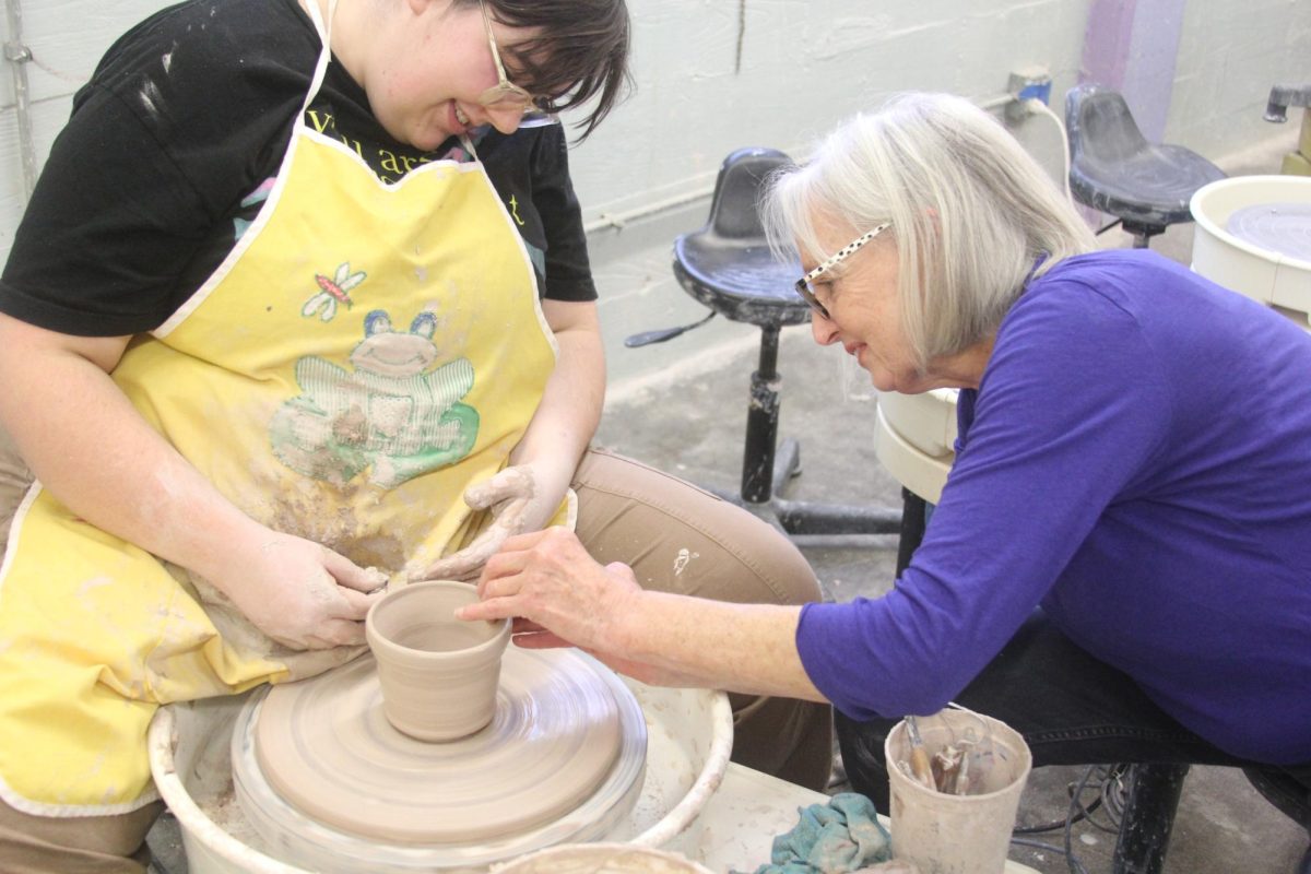 Professor Megan Quinn helps Senior Gray Cunner with making a mug out of clay in the Pottery Studio on Nov. 22.