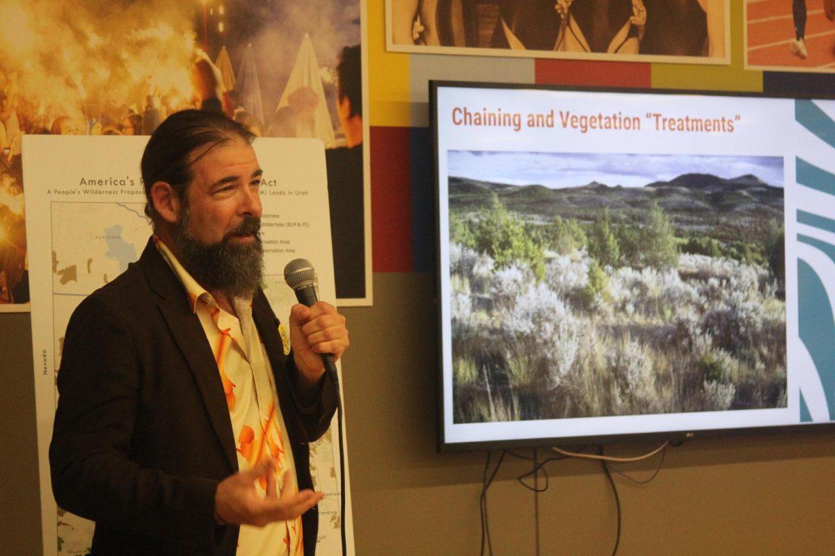 Guest speaker Chris Riccardo from the Southern Utah Wilderness Alliance (SUWA) gives a presentation about chaining and vegetation treatments at the 'From Red Rock to the Quad Cities: The 30x30 Initiative and Your Public Land' event on Nov. 19 in the Lindberg Commons.