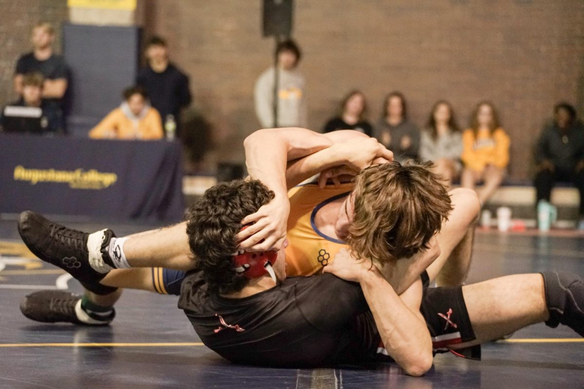 First-Year Noah DeMarco works to control his MSOE opponent on the mat during their
match, looking to secure back points in the dual meet in the Tim Dodge Wrestling Mezzanine at
Carver PE Center on Nov. 2, 2024.