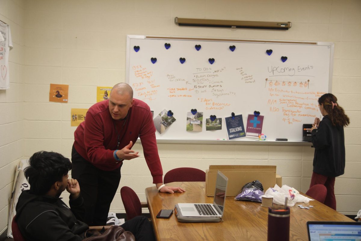 Senior Christina Bourtzoni and First-Year Aayush Dhakal work with Zach Draves, Director for Sexual Assault Prevention and Education in their office at Sorenson on Nov. 7, 2024.