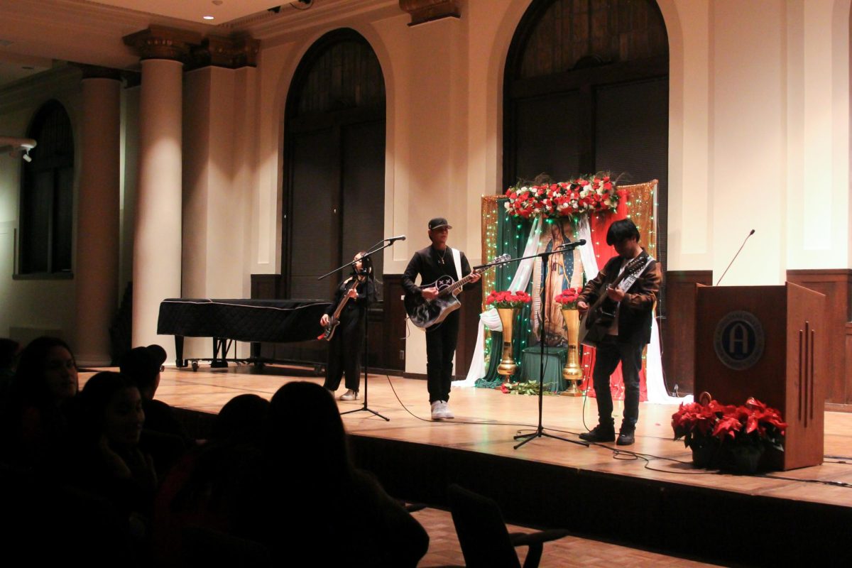 Performers blend voices and instruments, creating a powerful musical tribute during the Día de la Virgen celebration at Augustana College's Wallenberg Hall on Dec. 7, 2024.