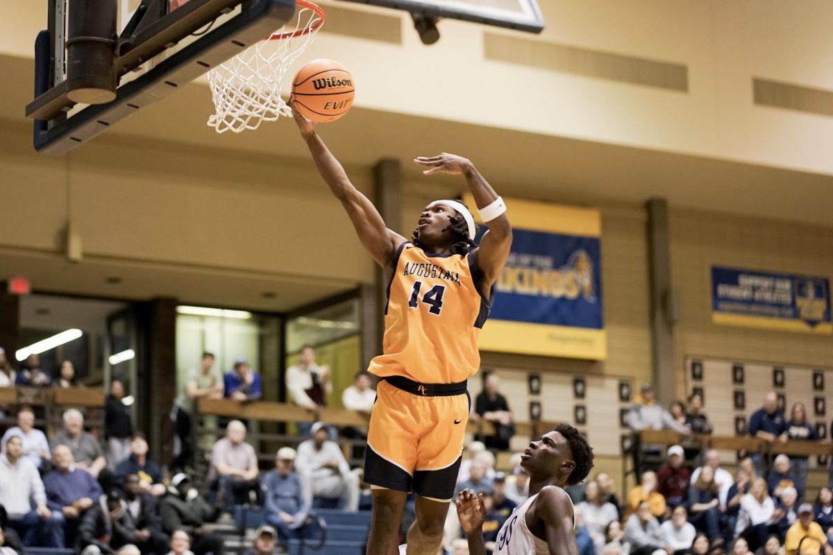 Junior Staishaun Kelley (#14) drives to the basket for a layup during the CCIW Quarterfinals against Elmhurst University at Roy J. Carver Center on Feb. 25, 2025. The Augustana team claimed victory with a final score of 92-78.