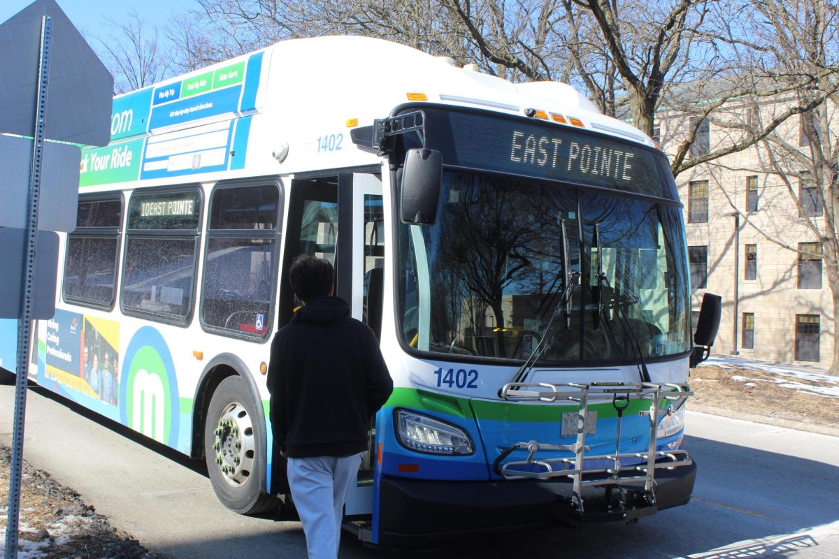 Sophomore Yashash Sthpit waiting for the bus at the bus stop near Old Main, on Feb 23, 2025.