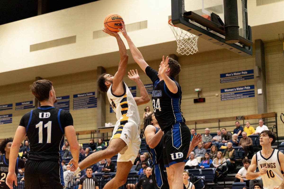 Junior Ray Maurchie goes up for a shot as Dubuque's defense contests during the Vikings' home game. The Augustana Vikings men's basketball team dropped a tough battle to the Dubuque Spartans by a score of 88-82.