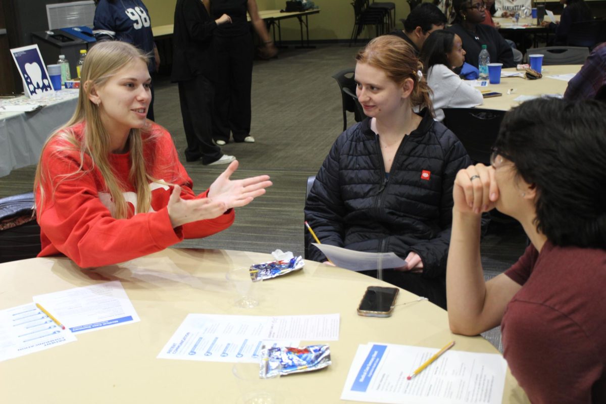 From left, juniors Addison Syzmborski and Sara Zogman practice imaginary patient and provider scenarios at the "Beyond the White Coat" workshop in the Gävle Room on April 1, 2026. "Beyond the White Coat" was presented by Kidist Tsige, senior, who highlighted patient trust, misinformation and cultural awareness in health communication.