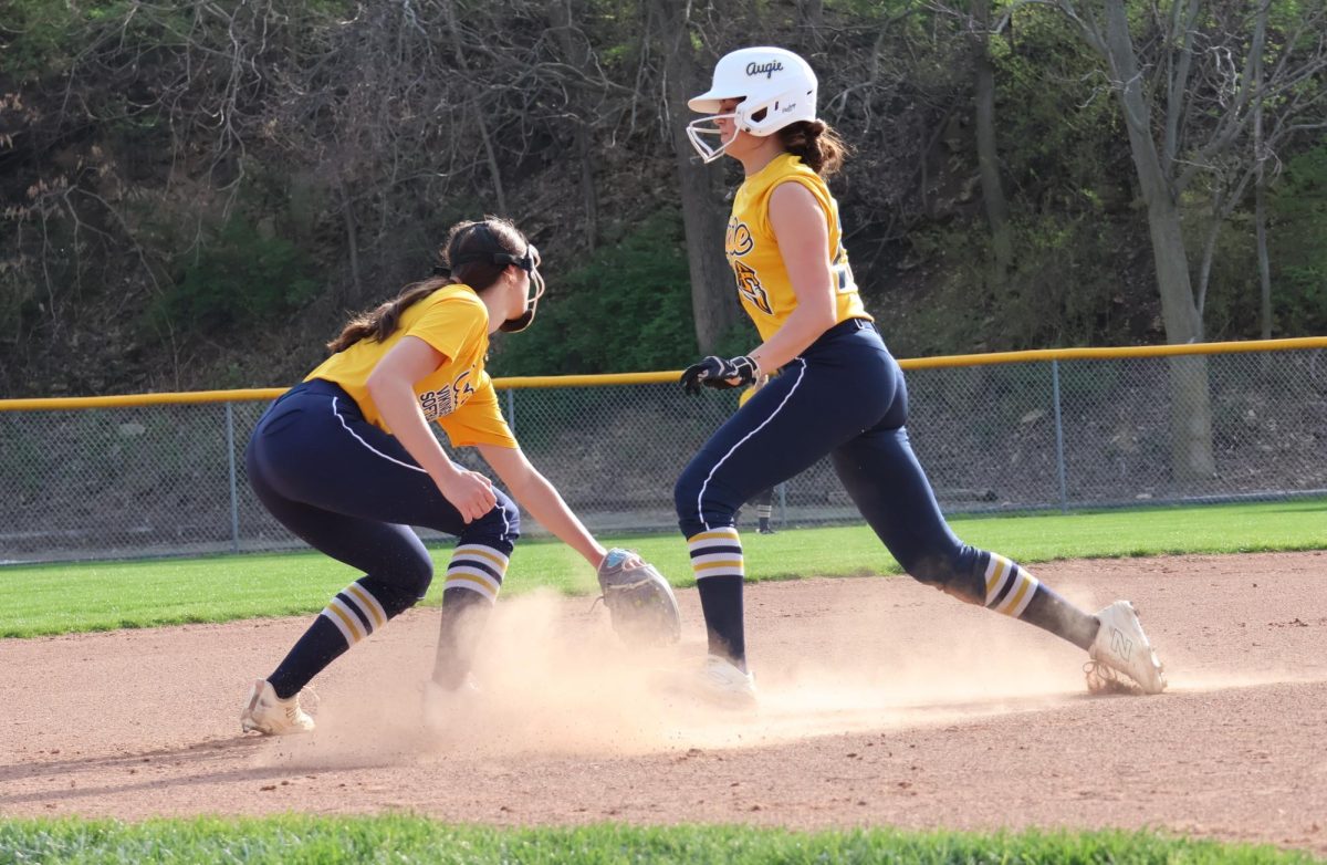 Mya Brown, left, goes to tag out Jenna Becker, right, during practice at Carver Field on April 15, 2026.
