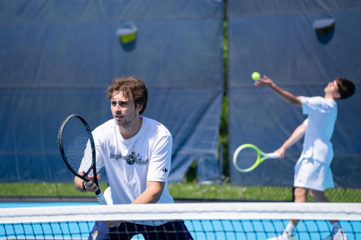 Junior Aingeru Garcia, left, readies at the net as first-year Jorge Marcelo serves during doubles play in the Vikings' final home match of the season against Luther College, Sunday, April 26, 2026, at Lincoln Park. Augustana fell to the Norse 6-1.
