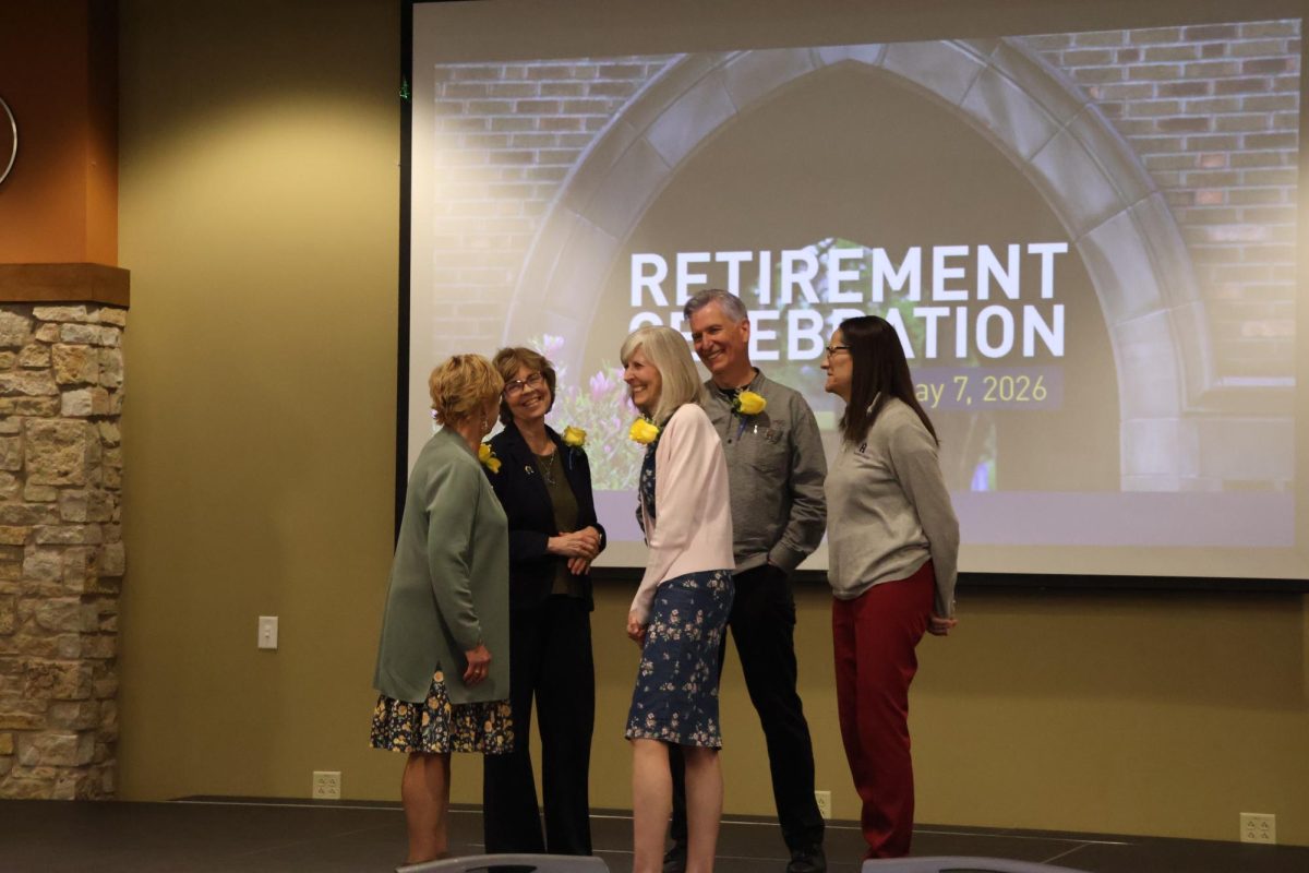 Augustana College faculty and staff gather in the Gavle Rooms on May 7, 2026, celebrating a retirement and reflecting on impactful moments throughout a career at Augustana.