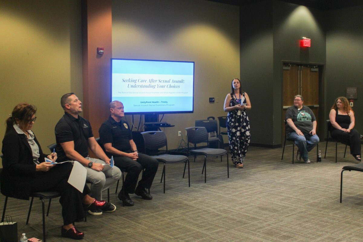 A sexual assault nurse examiner from UnityPoint Health - Trinity presents during a symposium marking Sexual Assault Prevention Month on April 21, 2026, in the Gavel Room at Augustana College